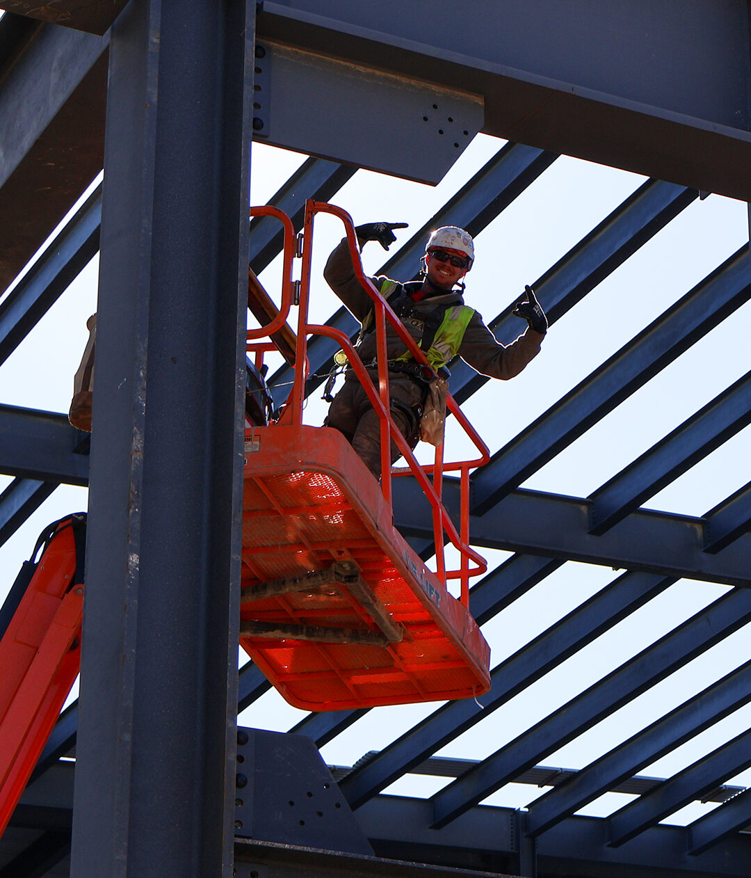 Employee in red crane working at a construction